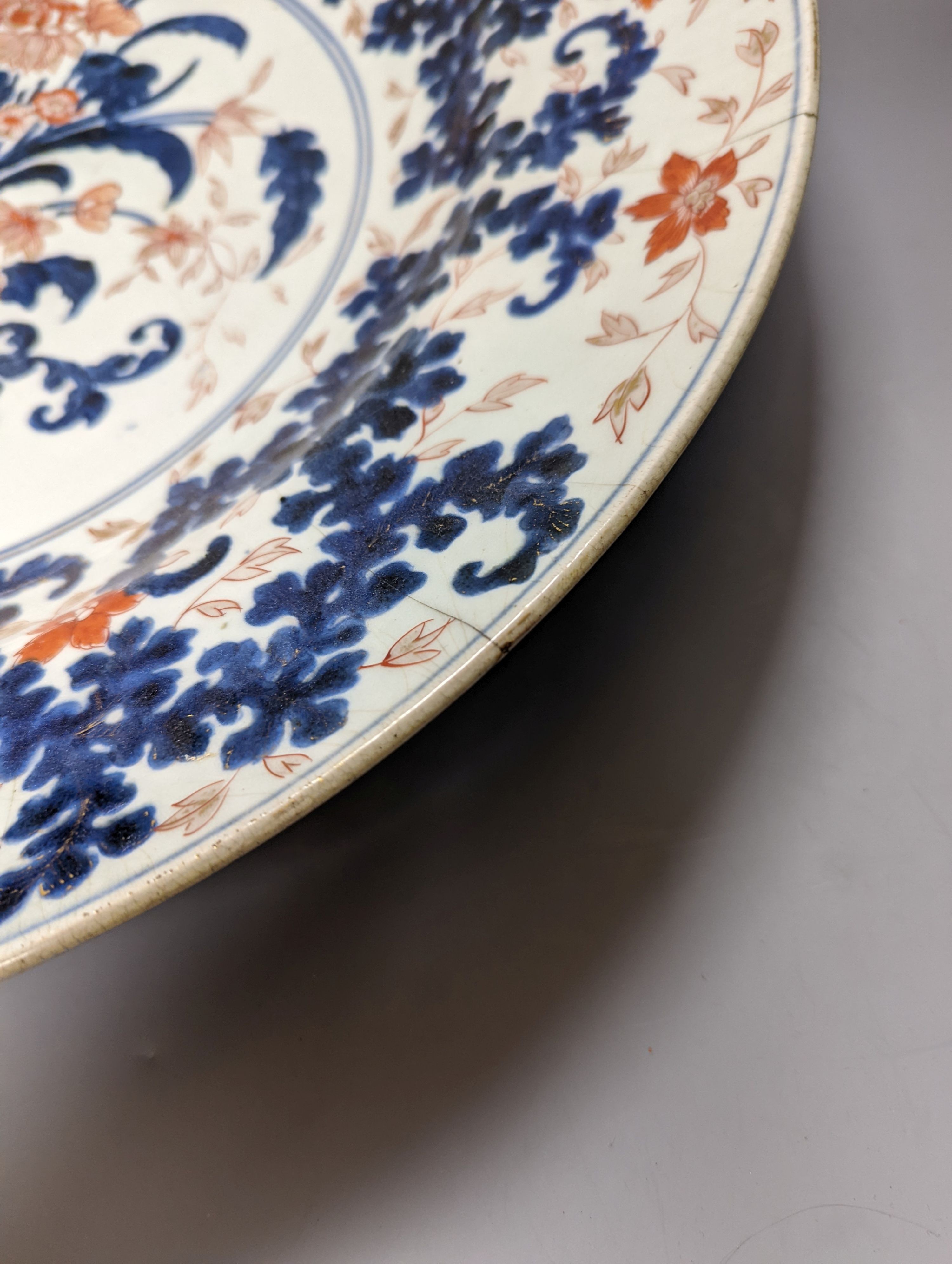 A large 17th/18th century Japanese Arita Imari palette charger, 55cm